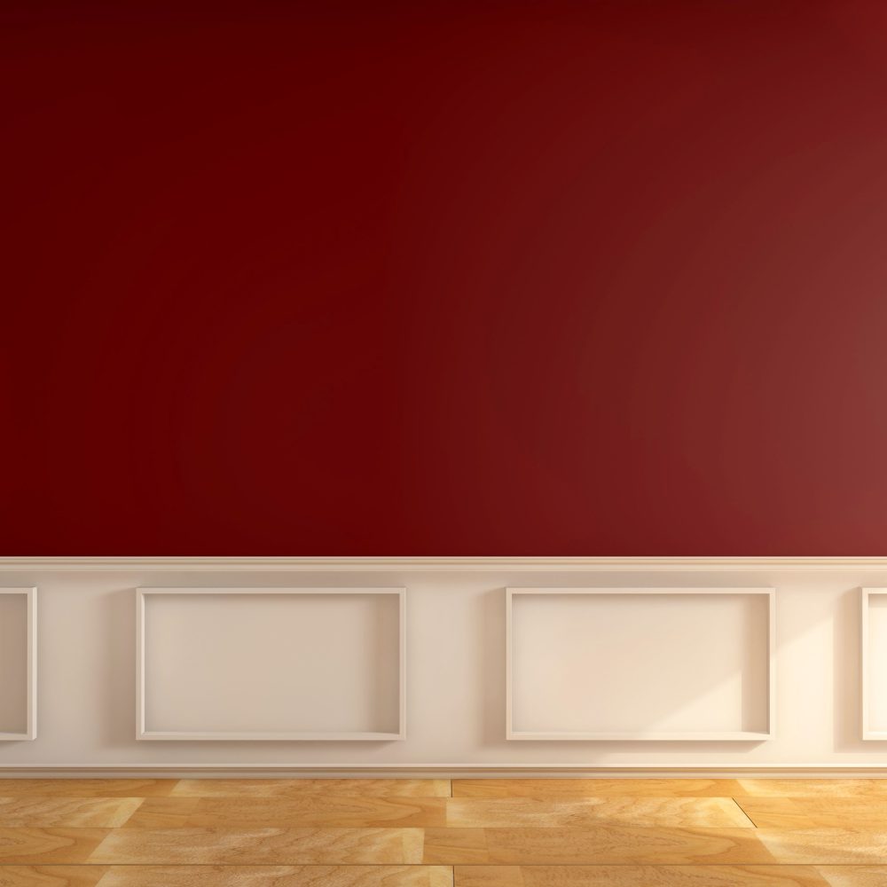 A room with a wooden floor and a red wall