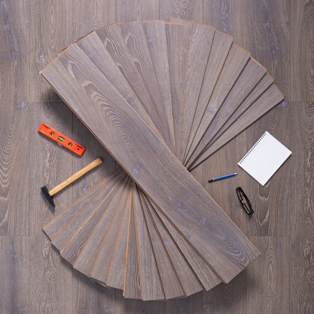 Wood laminate floor and tools background texture. Wooden laminate floor with tool